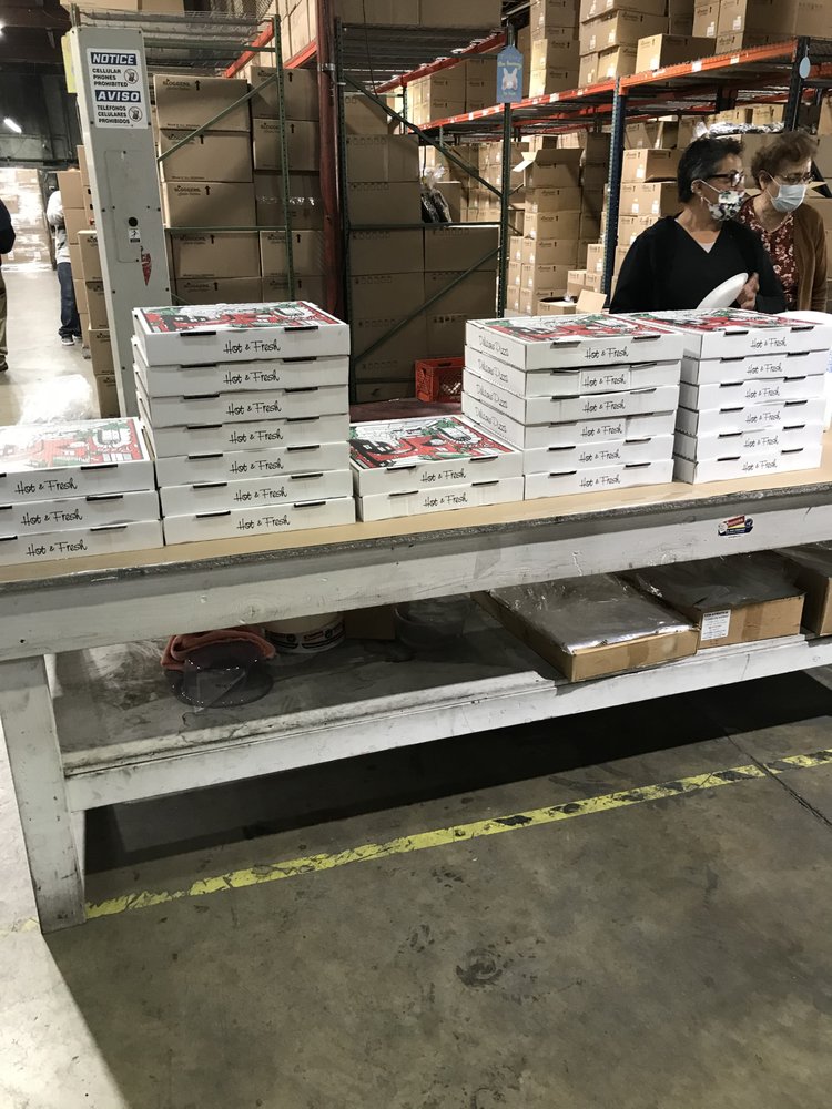 Stacks of Pizza King catering boxes ready for delivery